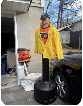 Flyers mannequin standing near the outdoor toilet