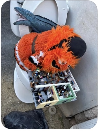 Gritty seated on the outdoor toilet